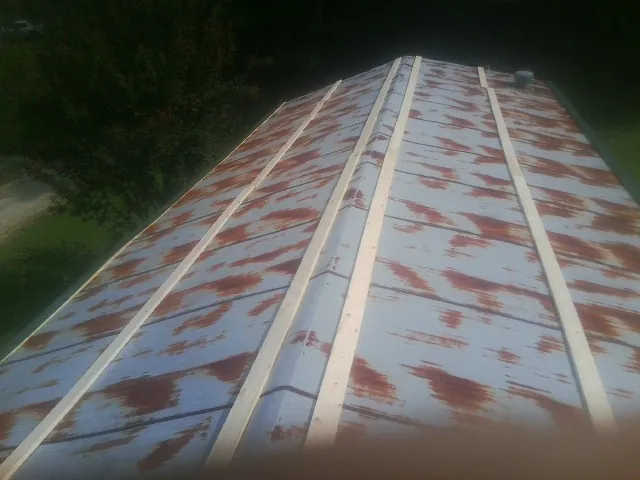 Rusted metal roof panels with new wood purlins before replacement — Storm Damage Roof Repair in Valley View by Roofing Brothers