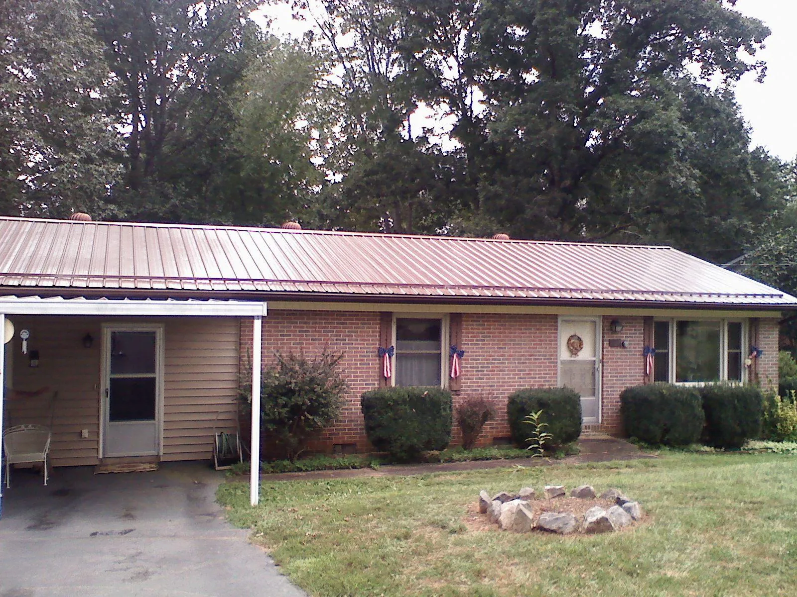 Bronze metal roof and carport on a brick ranch home — Roof Repair work by our crew in Valley View